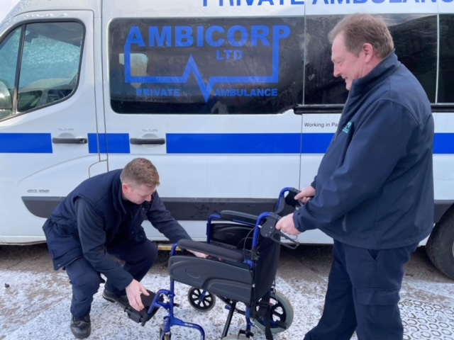 Ambicorp Ambulance staff looking at wheelchair